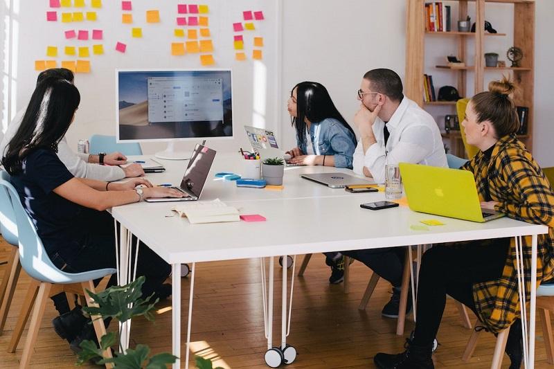 A team in an office discussing federated search during a meeting